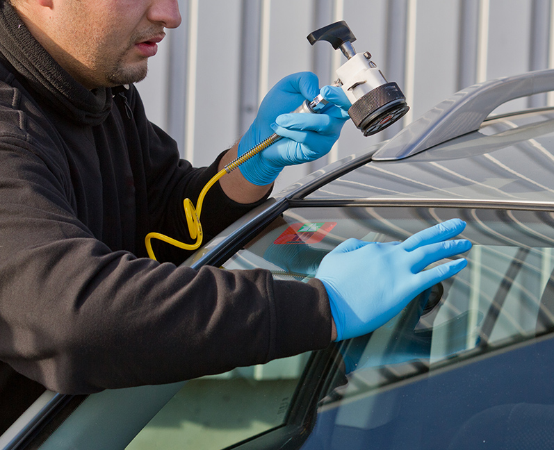 Service agent repairs damaged windshield on location without replacement glass for free, Smart repair