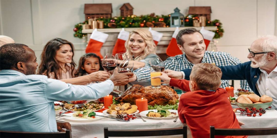 diverse family members toasting at holiday dinner