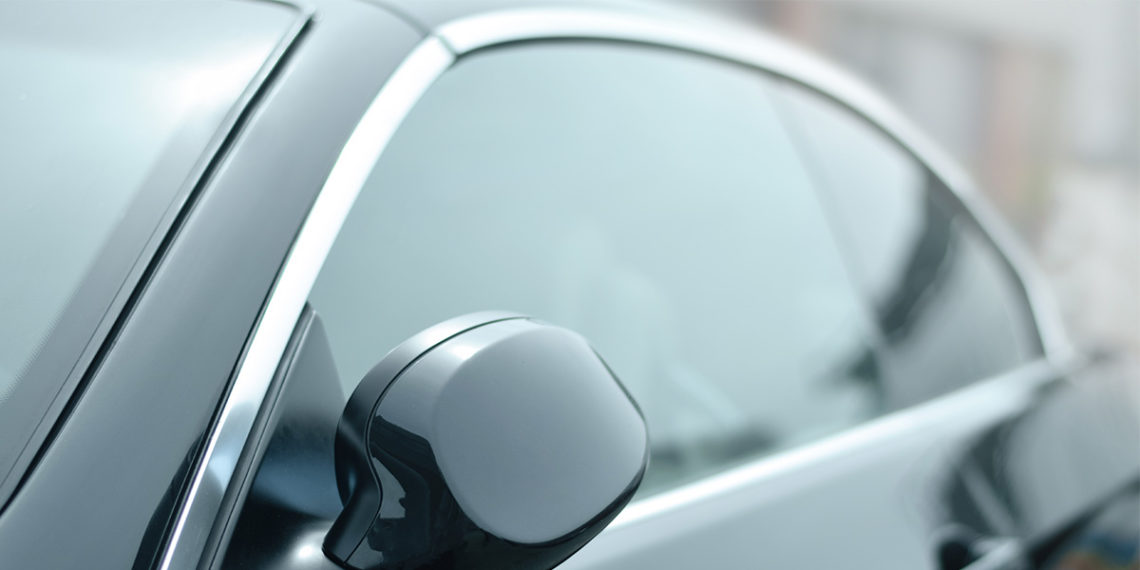 side view of black car with dark tinted windows