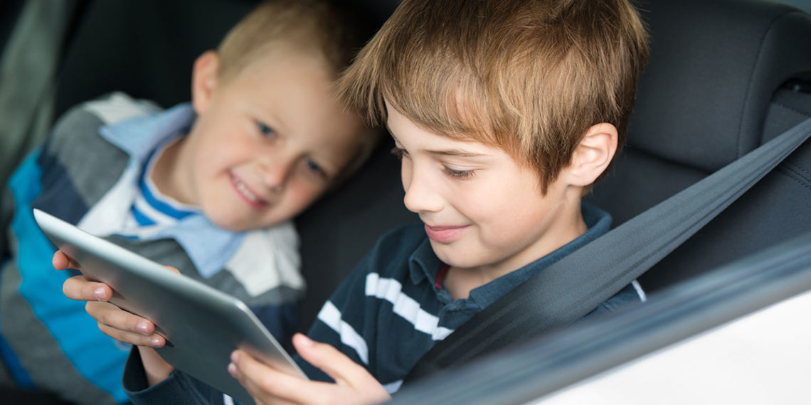 Kids playing games in a car