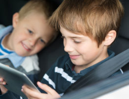 Kids playing games in a car