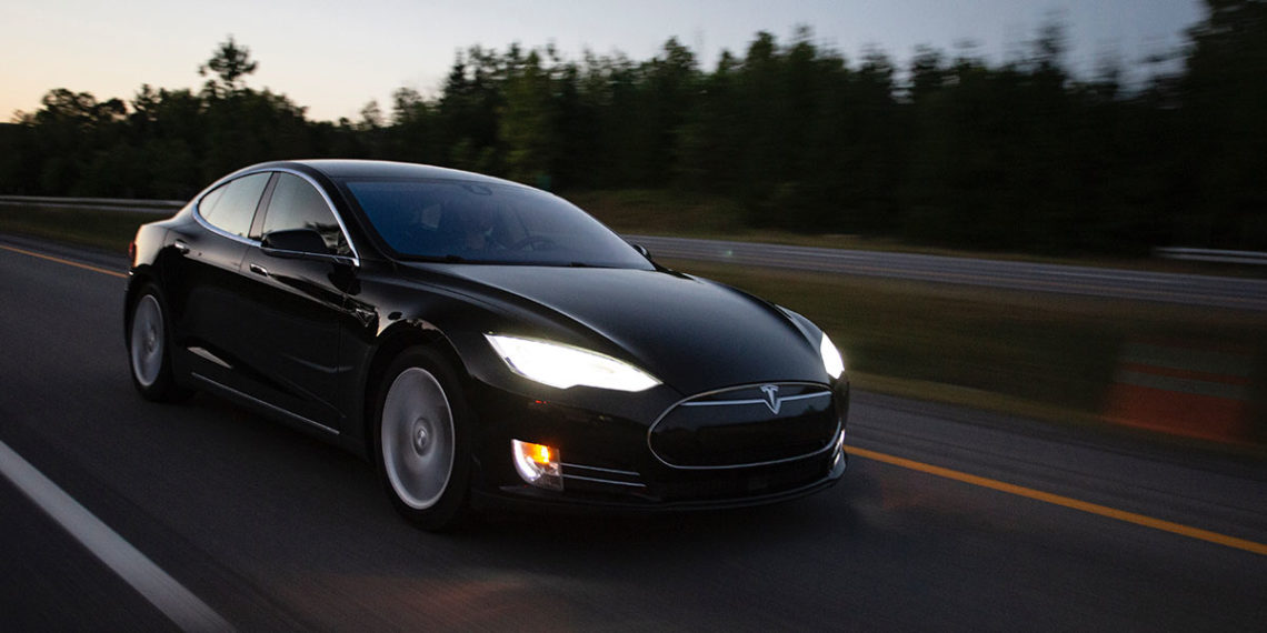 Tesla driving at dusk