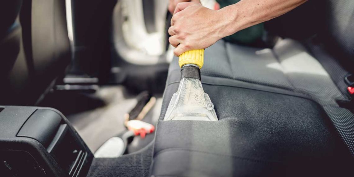 Car upholstery being steam cleaned.